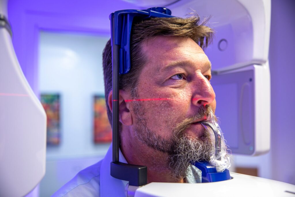 Alignment laser on a patient's face during a cone beam CT scan for dental implant planning