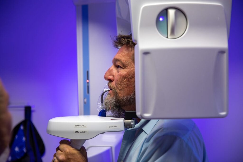 Dental implant patient positioned in the cone beam CT (CBCT) scanner at Winchester Dental Implant & Sedation Center