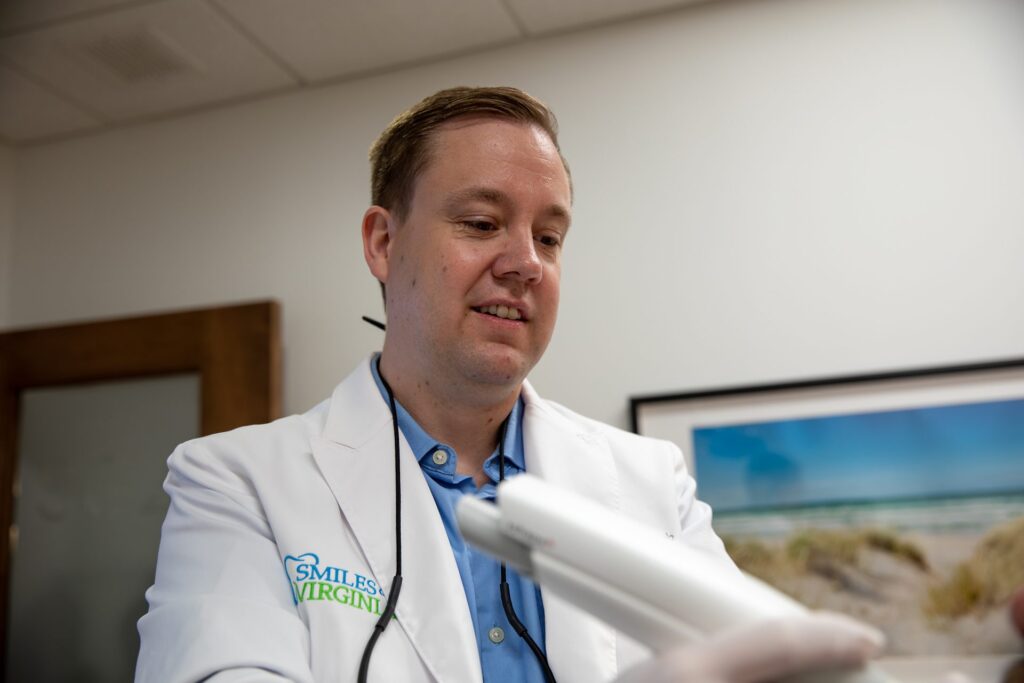 Dr. Niels Oestervemb holding an intraoral scanner used for digital impressions