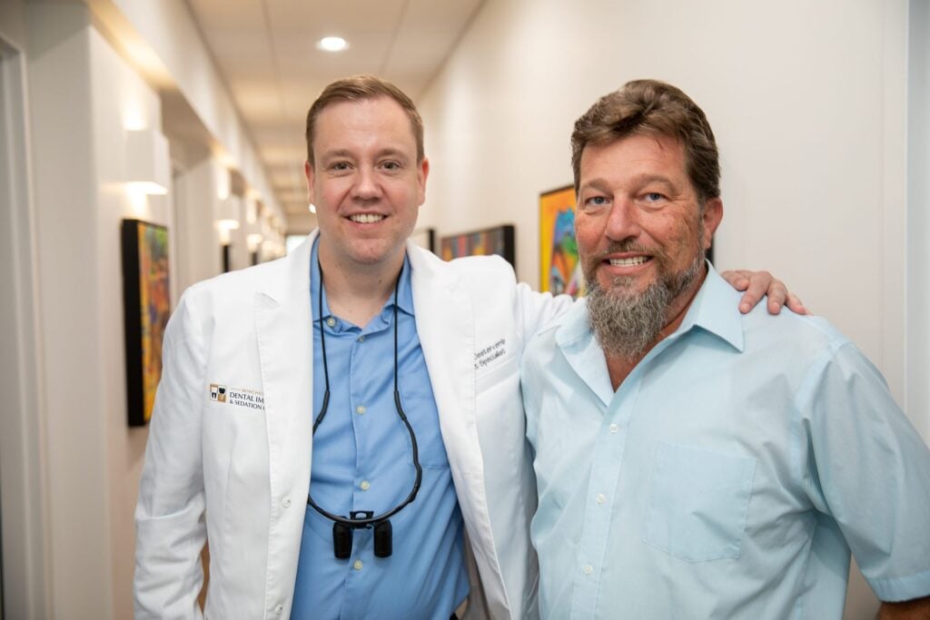 Dr. Niels Oestervemb with a happy upper All-on-4 dental implant patient at Winchester Dental Implant & Sedation Center