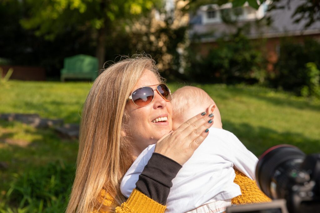 Full-mouth rehabilitation patient laughing with a young child outdoors