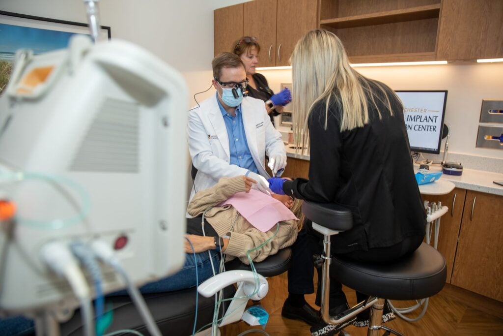 Dr. Niels Oestervemb treating a patient with the sedation monitor in the foreground